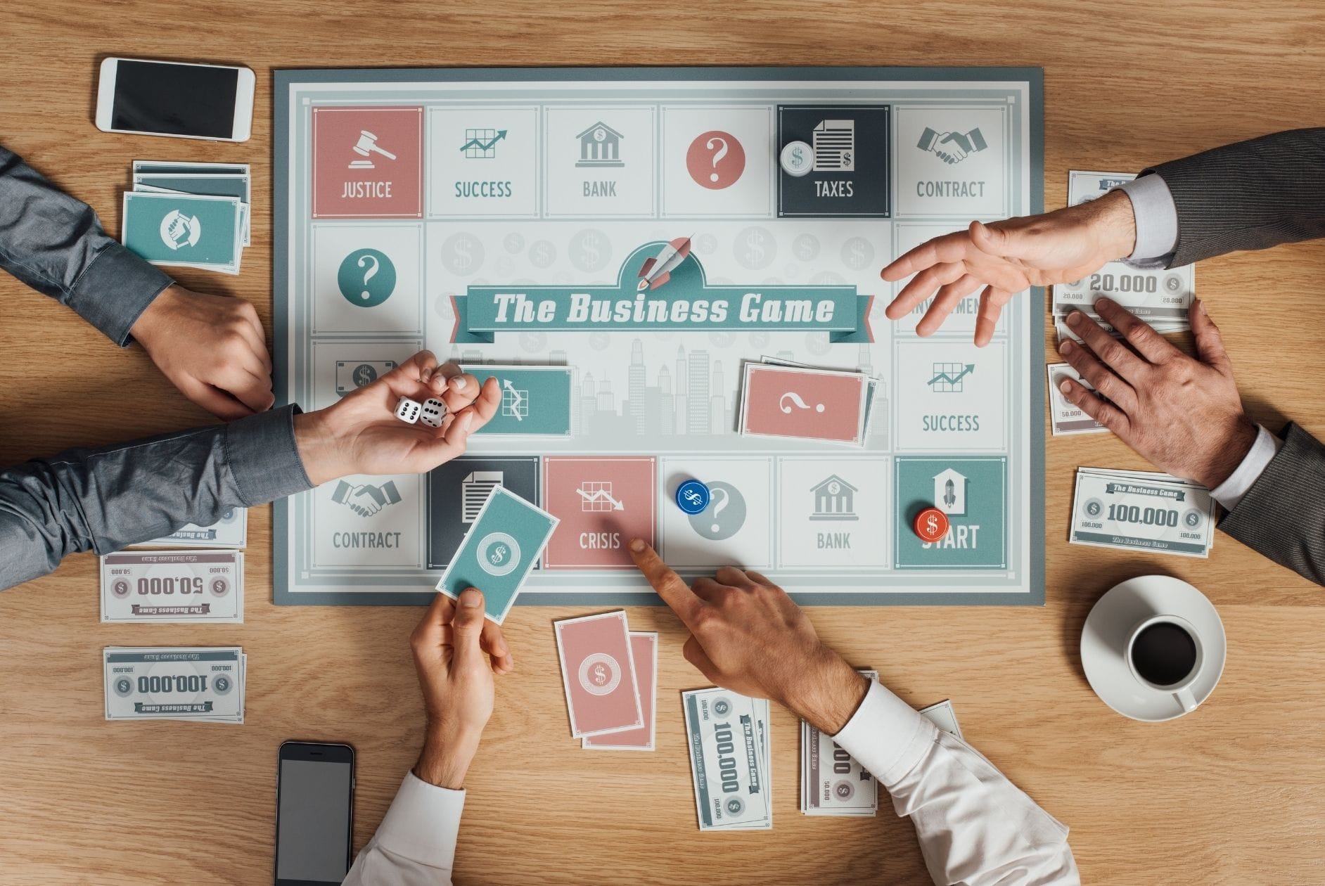 Spielbrett mit Aufschrift Business Game und Hände